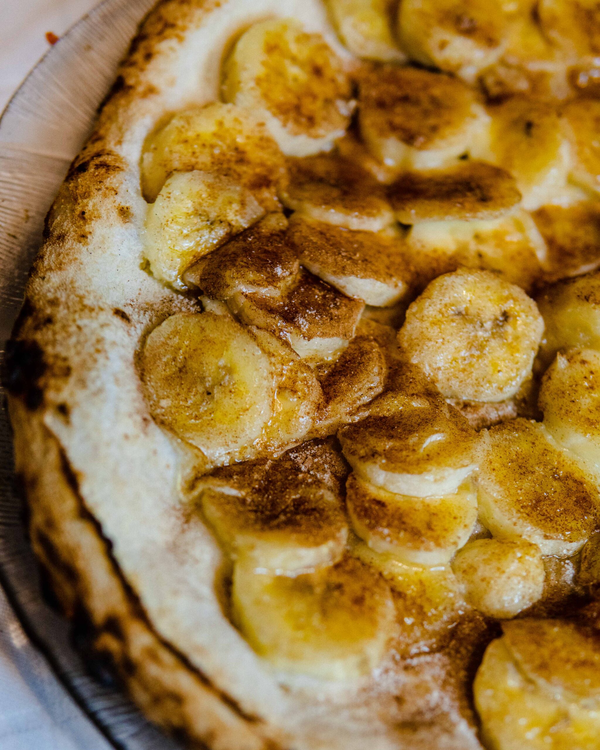 A closeup shot of a banana pizza slice