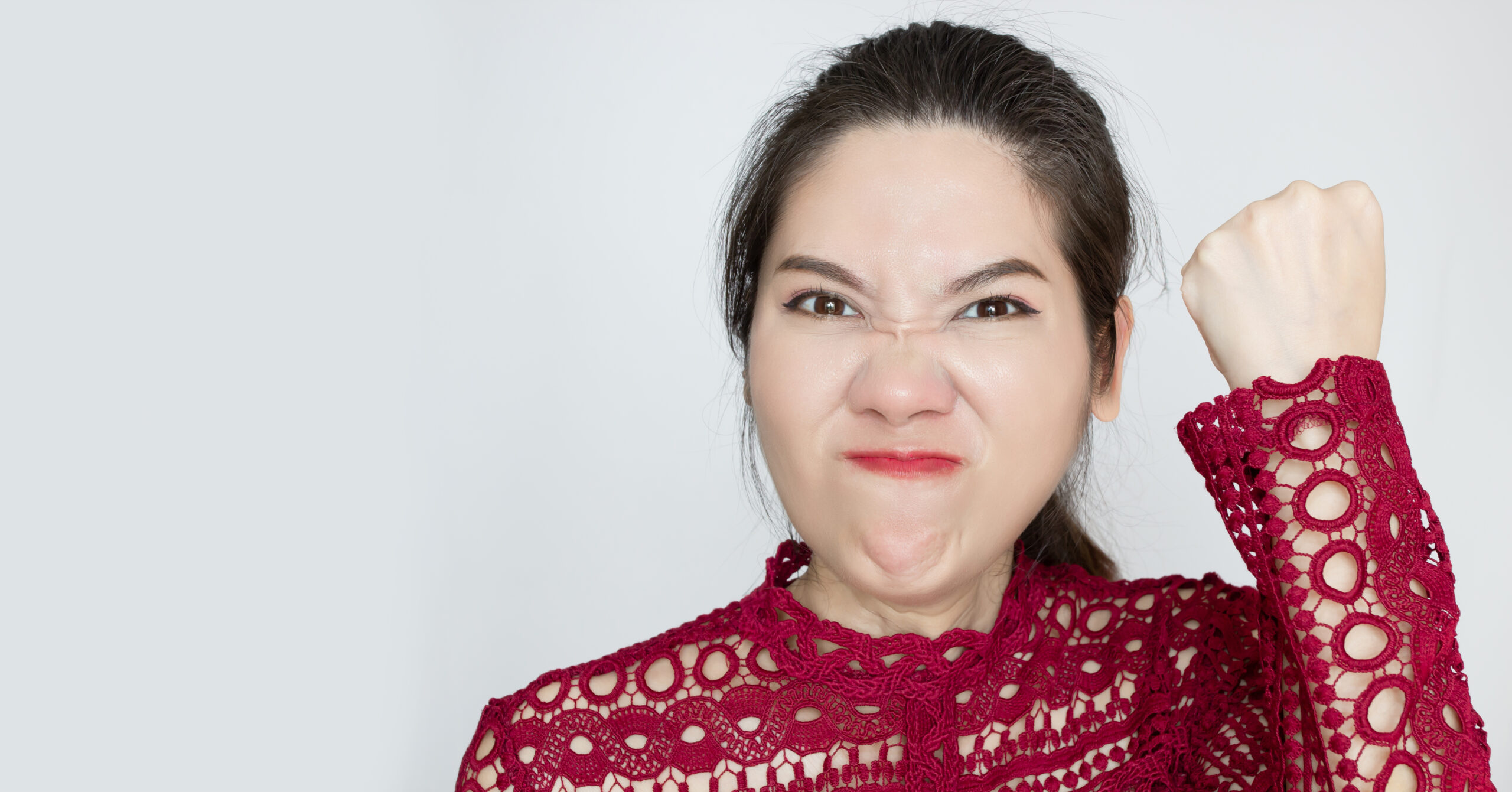 Closeup of bitter displeased pissed, angry cranky grumpy woman with fists . A Negative emotion facial expression