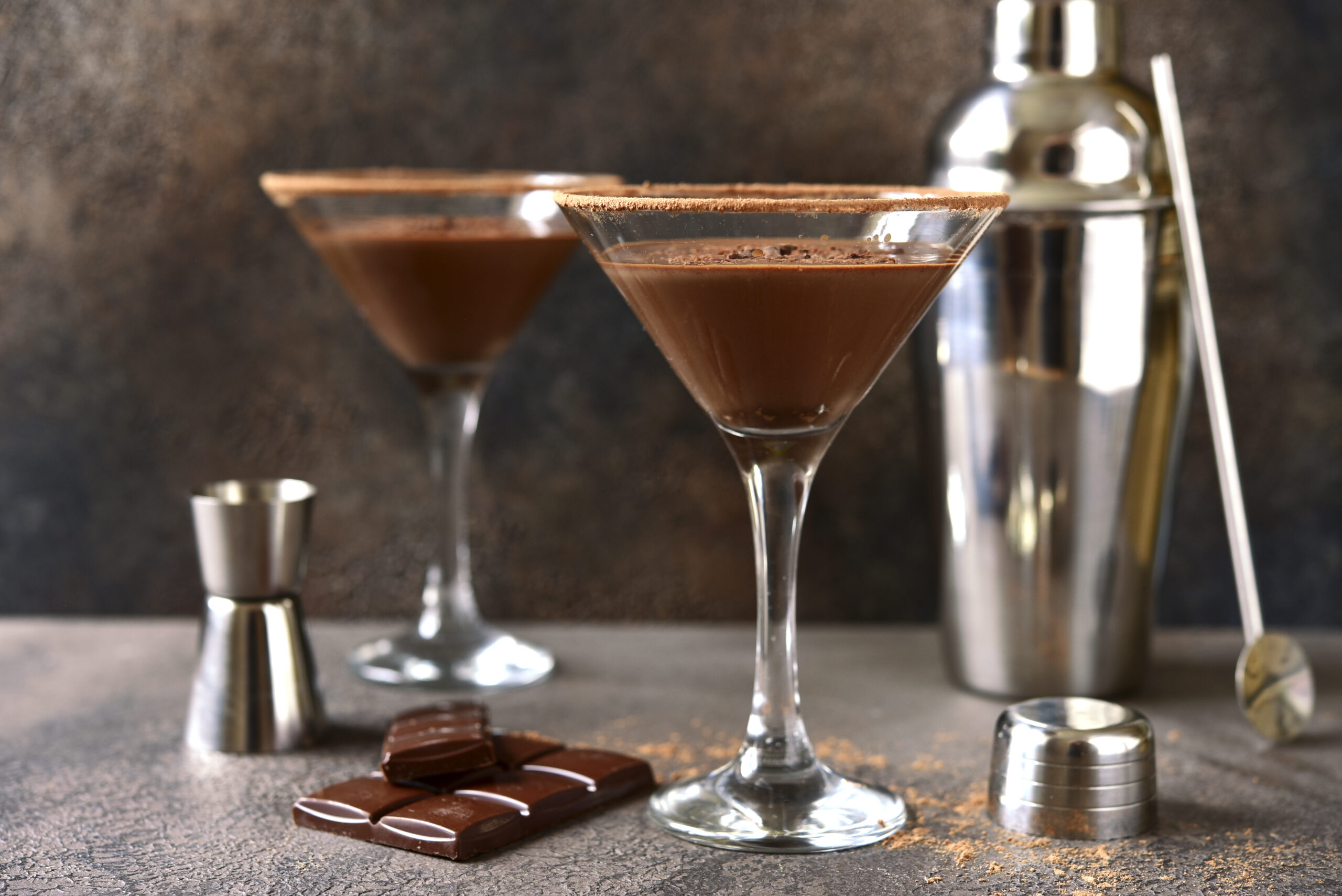 Delicious chocolate martini in a glasses on a dark slate, stone or concrete background.