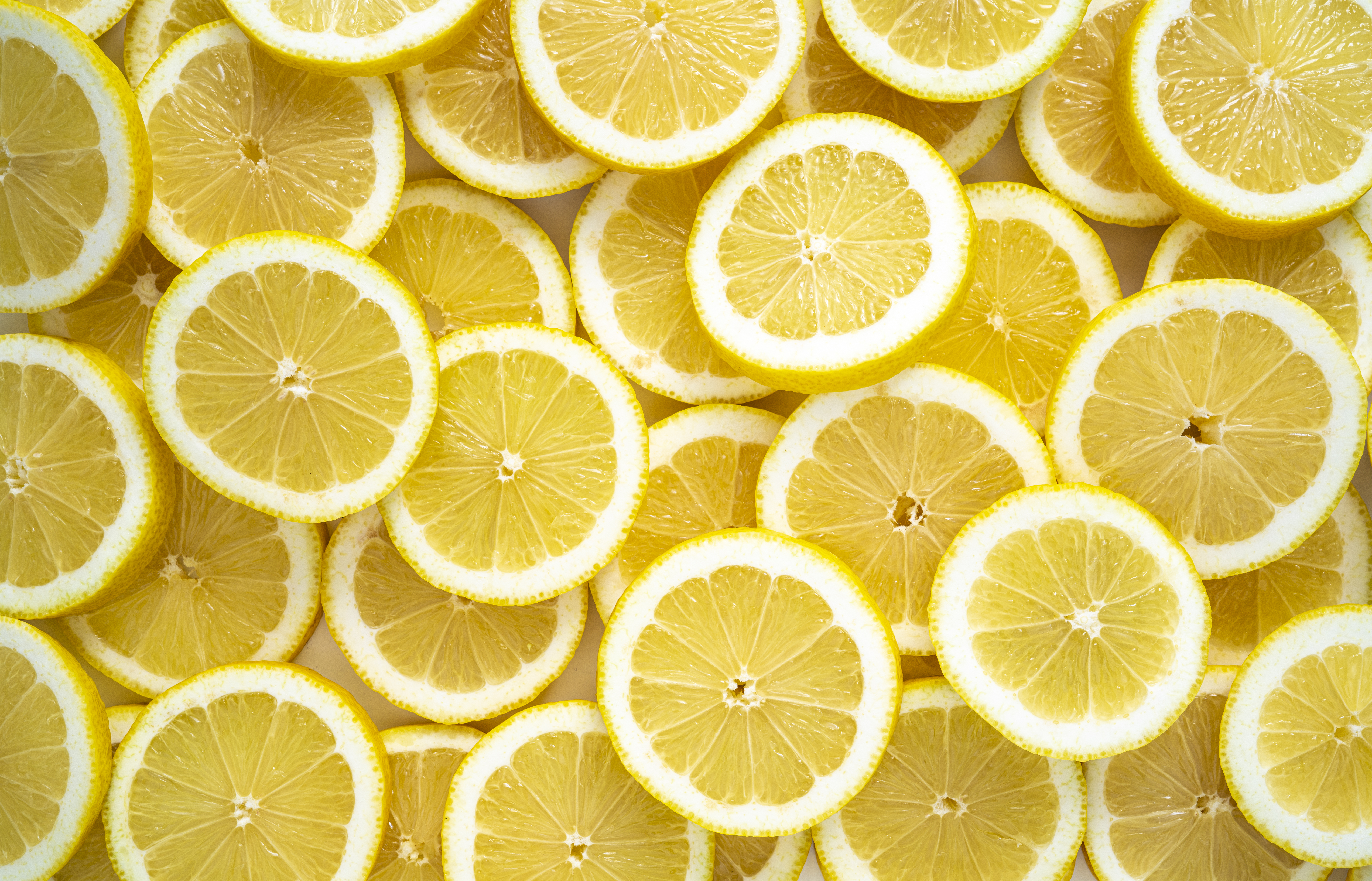 Lemon fruit slices arrangement in a row full frame background fresh citrus