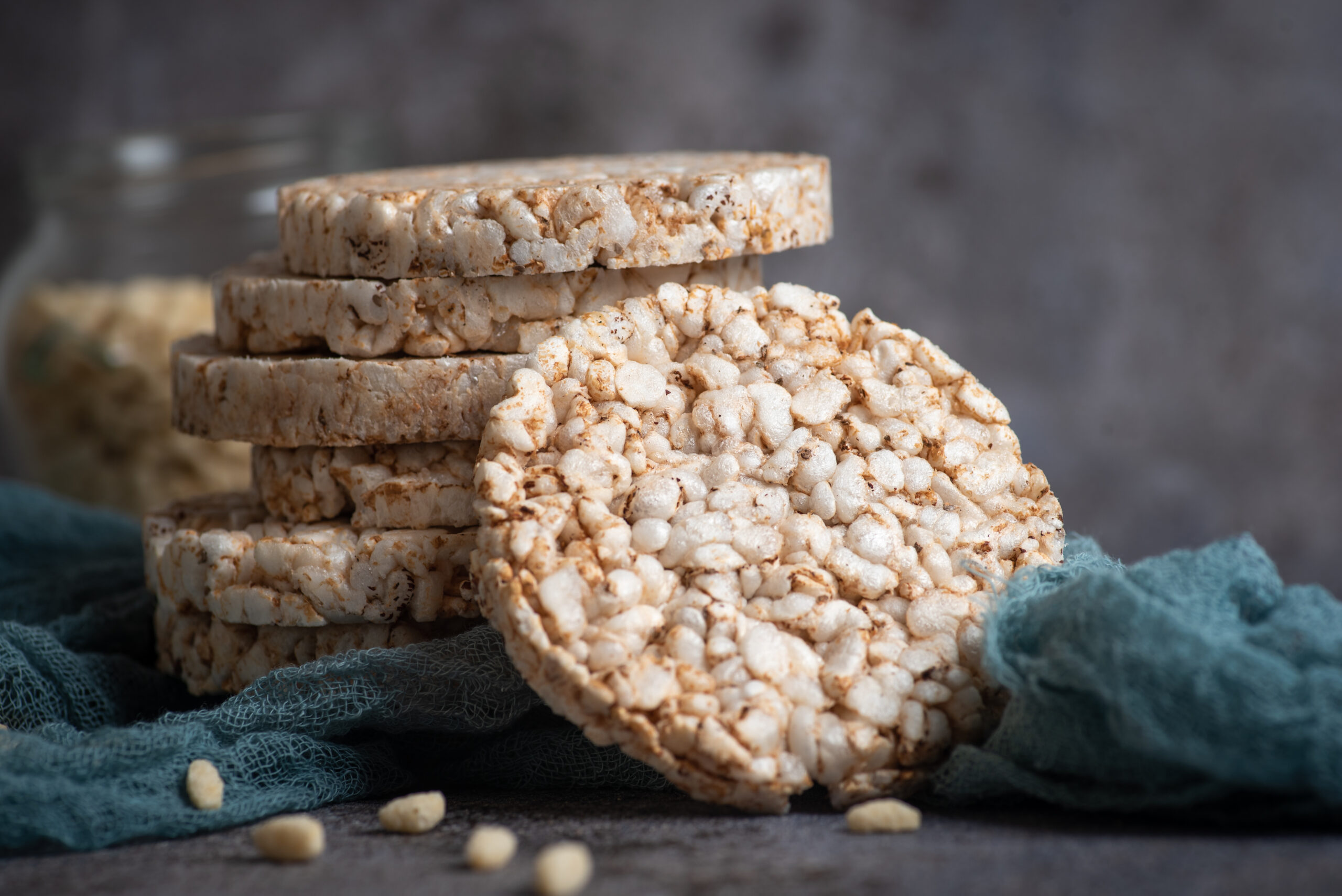 Rice cakes, gluten free. A bunch of round crispy cake puffs. Natural, sugar-free vegan energy food, on a gray rustic background