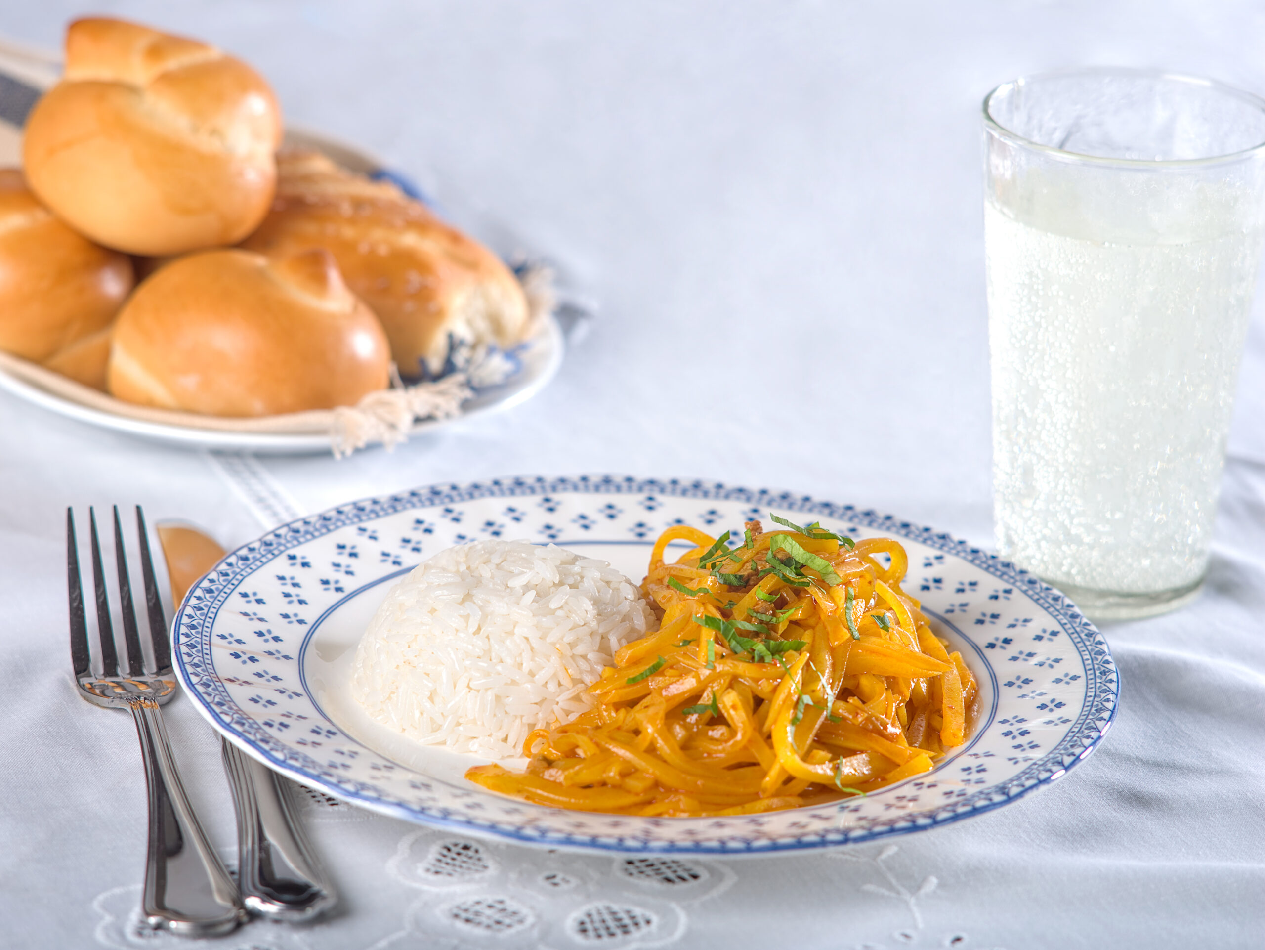 Olluquitos con charqui, a typical Peruvian potato dish with dried alpaca meat and white rice.  A dish originated in the Andes in Peru.