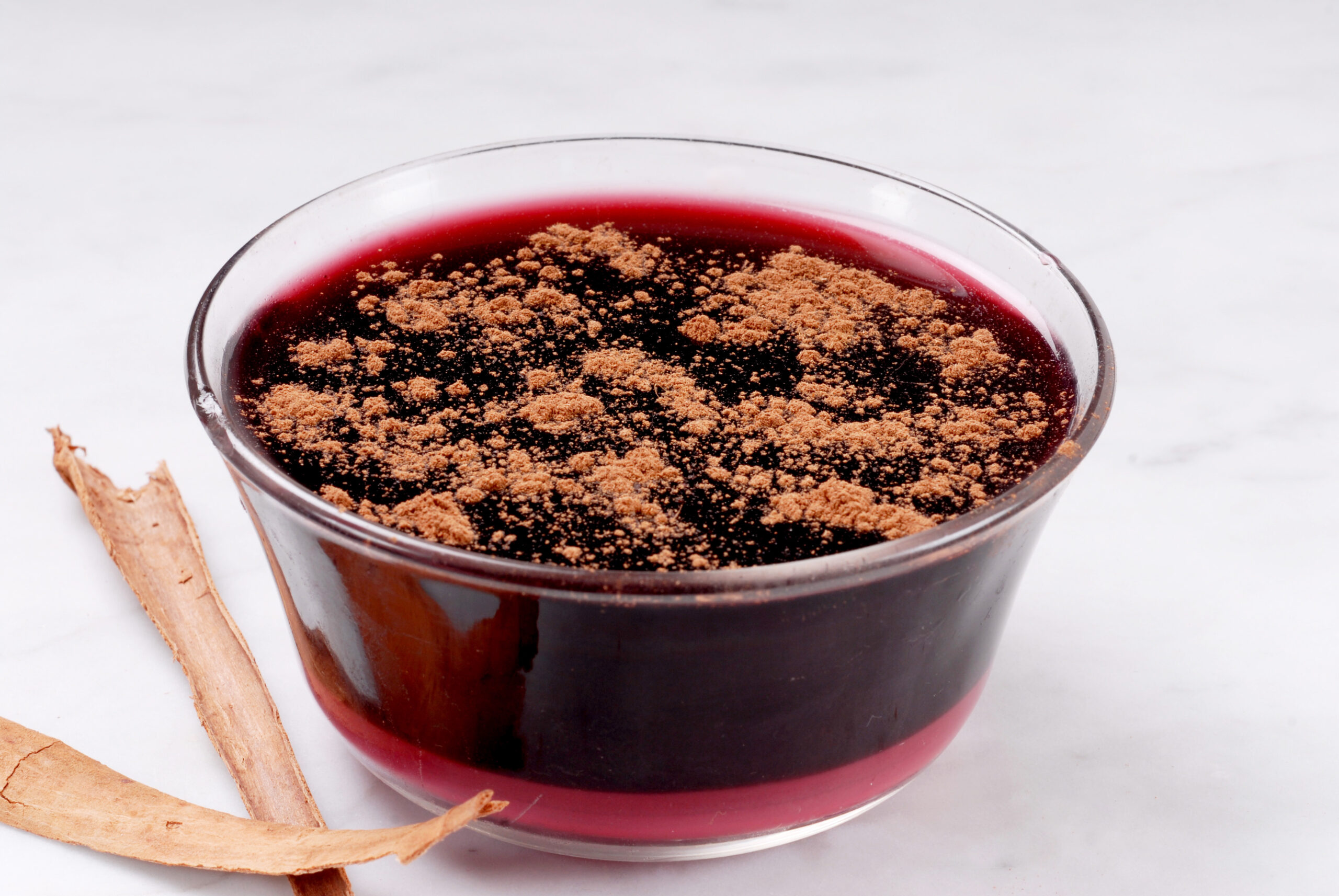 Popular Peruvian dessert called mazamorra morada the main ingredient purple corn visible in the back