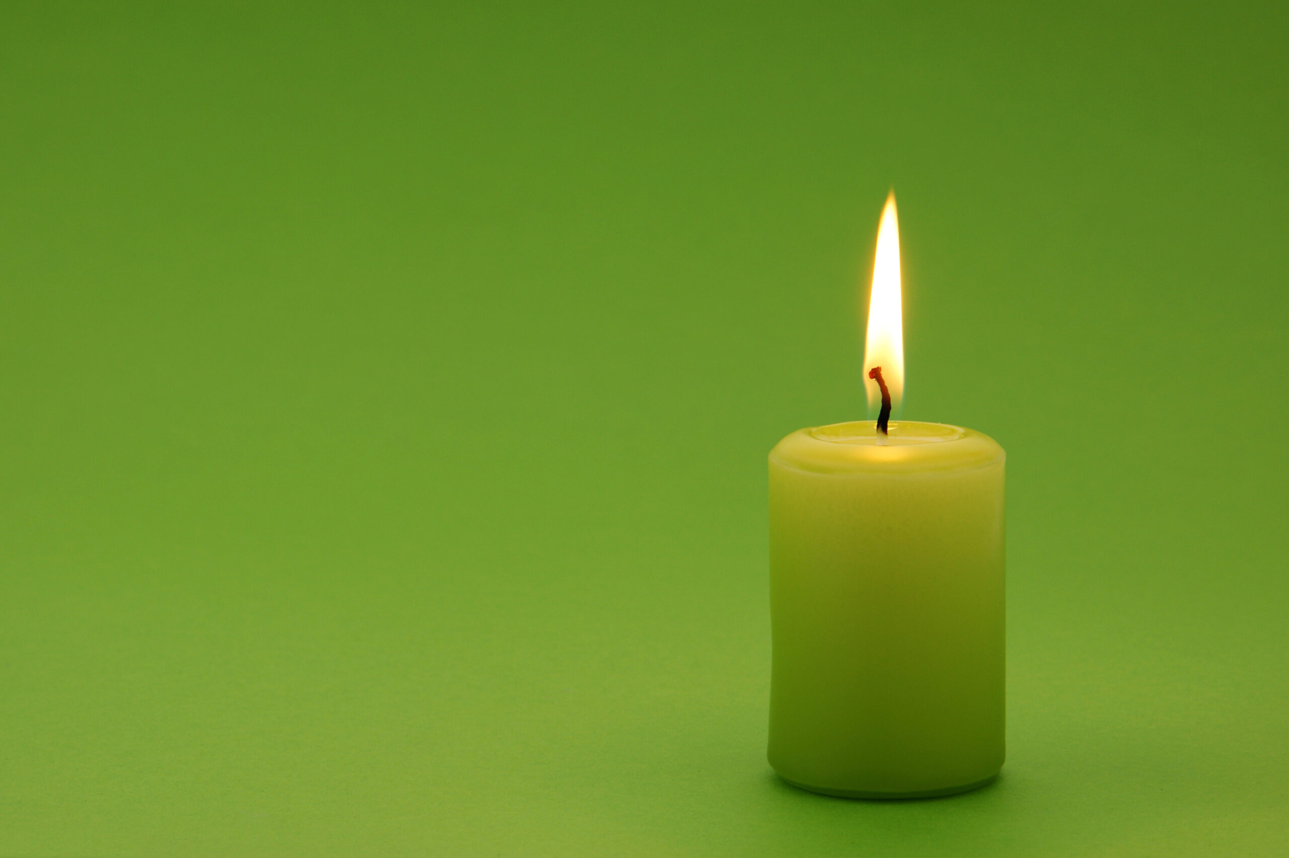 Green candle with copy space