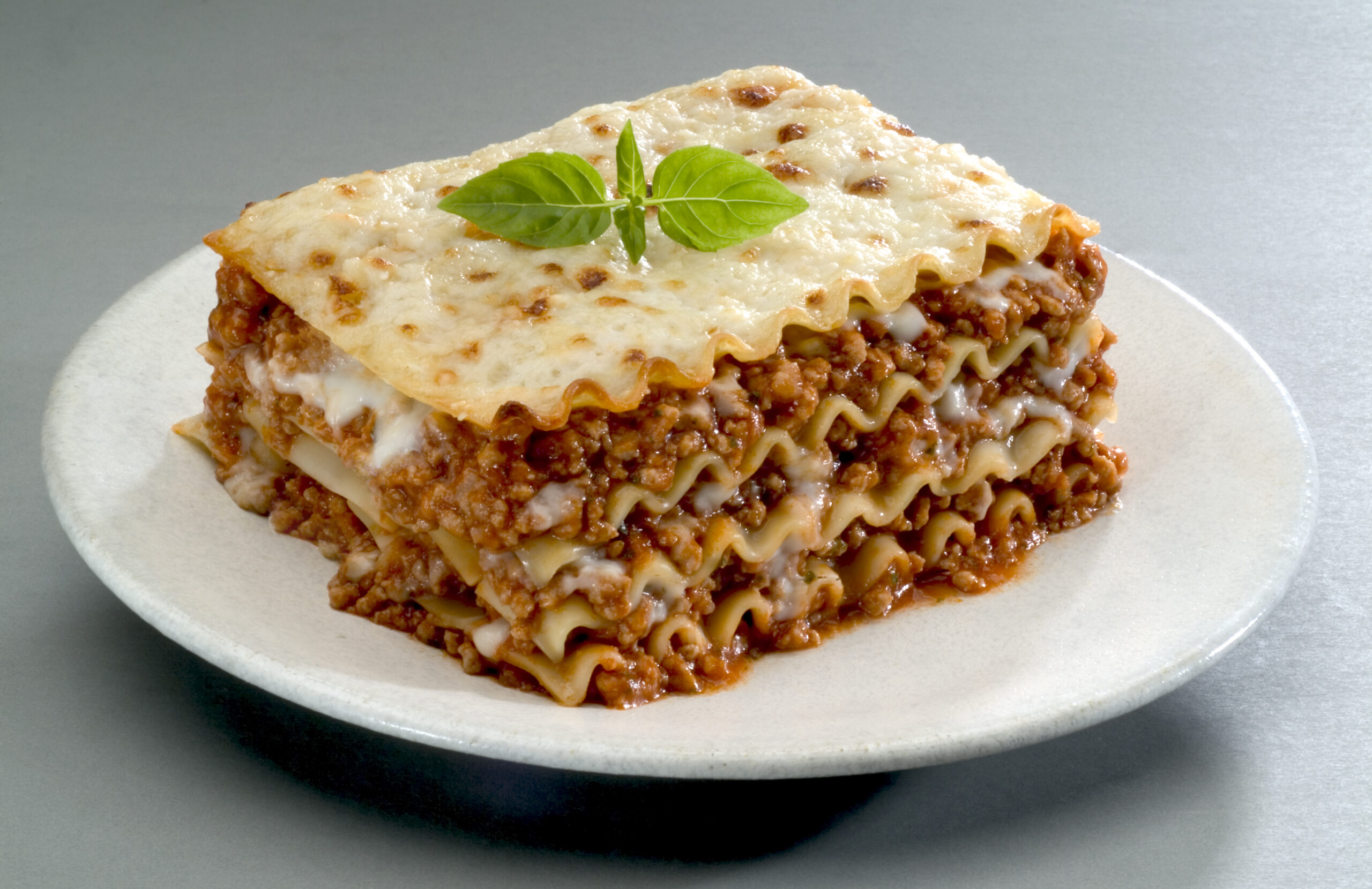 Traditional Italian pasta, lasagna is made with minced beef bolognese sauce with tomato, basil, and Mozzarella cheese."n