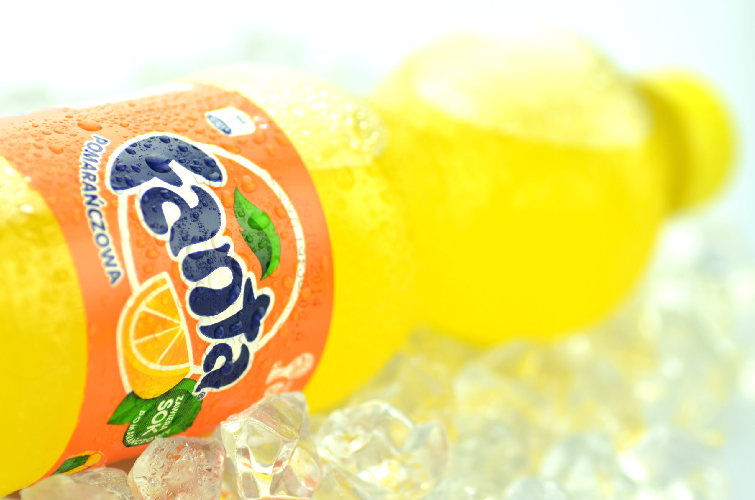 Kwidzyn, Poland - May 26, 2014: Bottle of Fanta drink on ice cubes. Fanta is fruit-flavored carbonated soft drink produced by Coca-Cola Company. Fanta was introduced in 1941