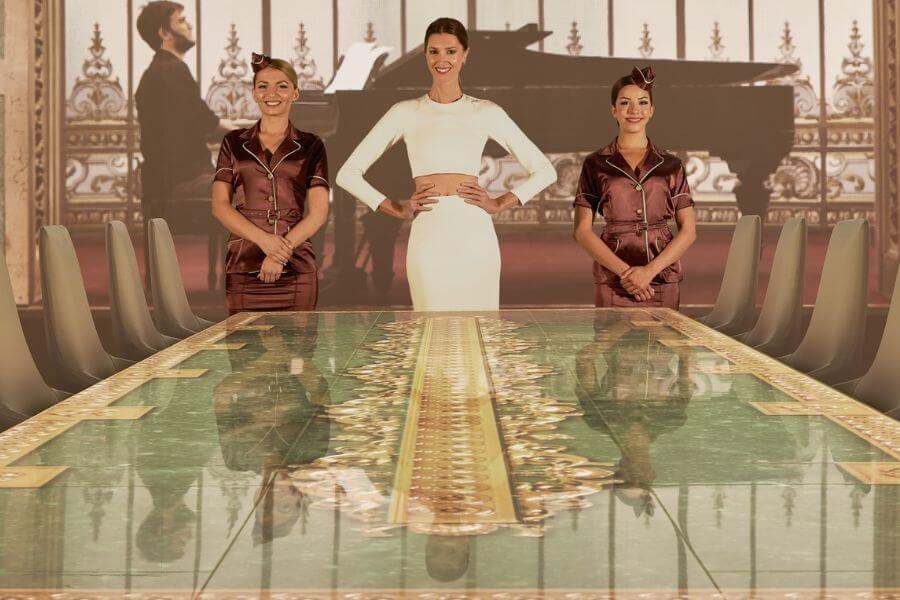 Three woman standing in front of a table