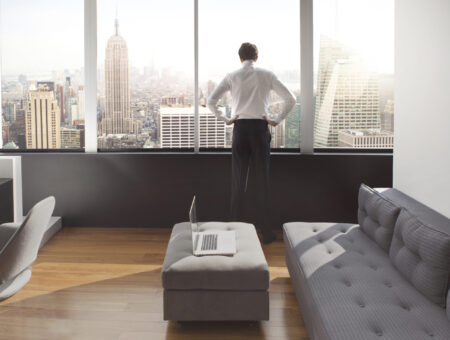 Young man looking out at city skyline. Composite image.