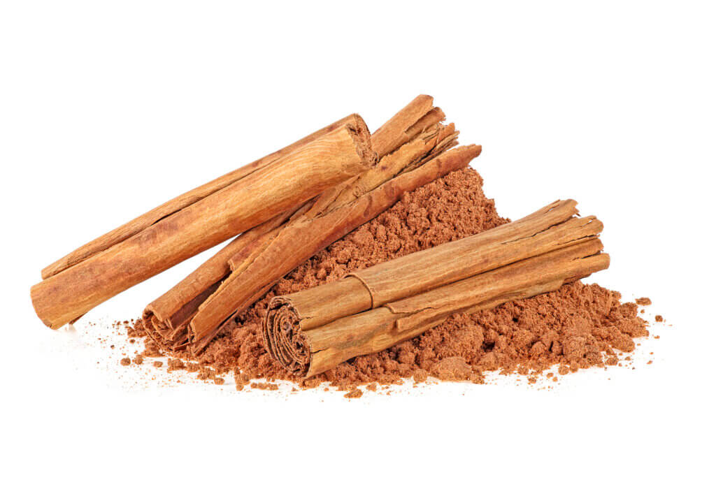 Cinnamon sticks and powder, white background. Ceylon cinnamon.