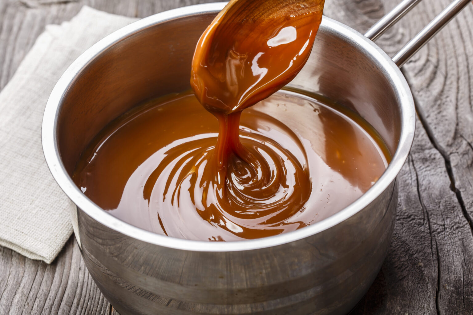 liquid caramel is poured into a gravy boat