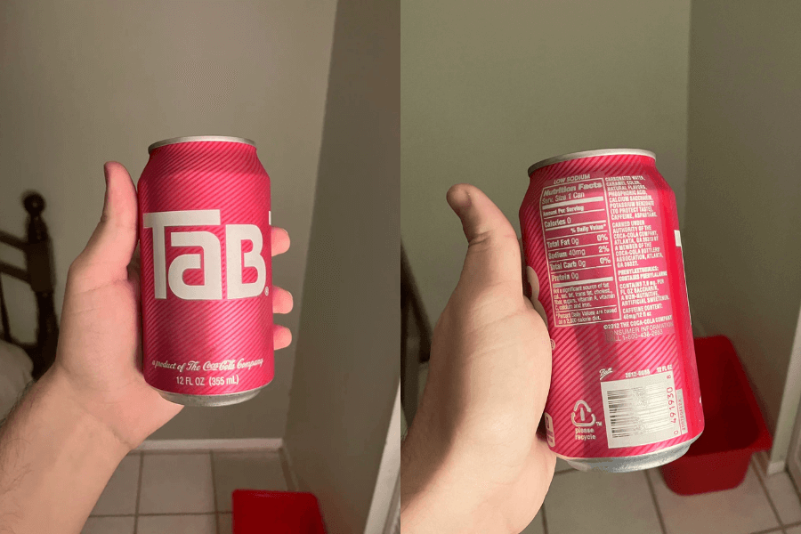 This image shows a hand holding a 12-ounce can of Tab soda, known for its retro pink design with bold white lettering. The second perspective highlights the nutritional facts and product details on the back of the can, showcasing its "low sodium" label.