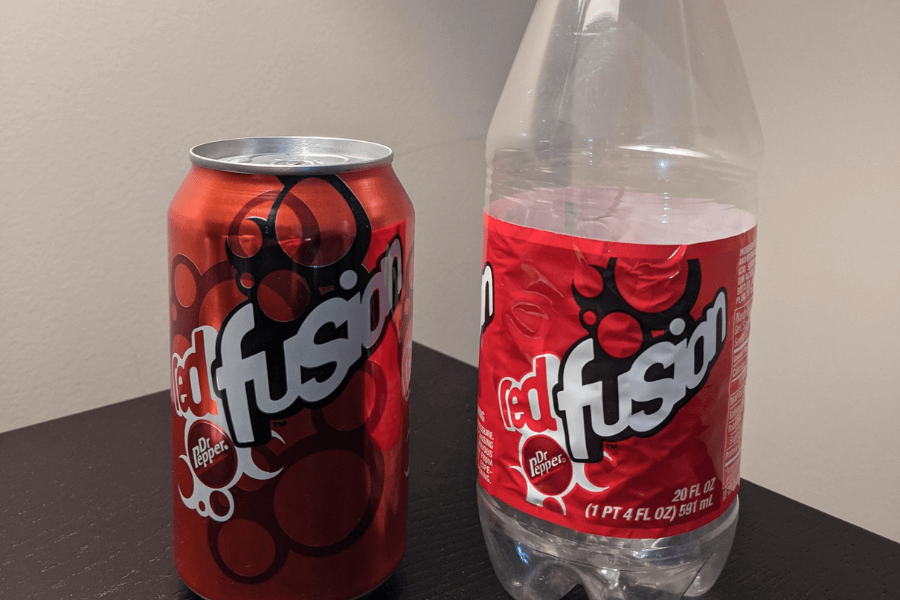 This image displays a can and a bottle of Dr Pepper Red Fusion, characterized by its bold red design with swirling patterns and bubble-like accents. The branding prominently features the "Red Fusion" logo in contrasting white and black text.