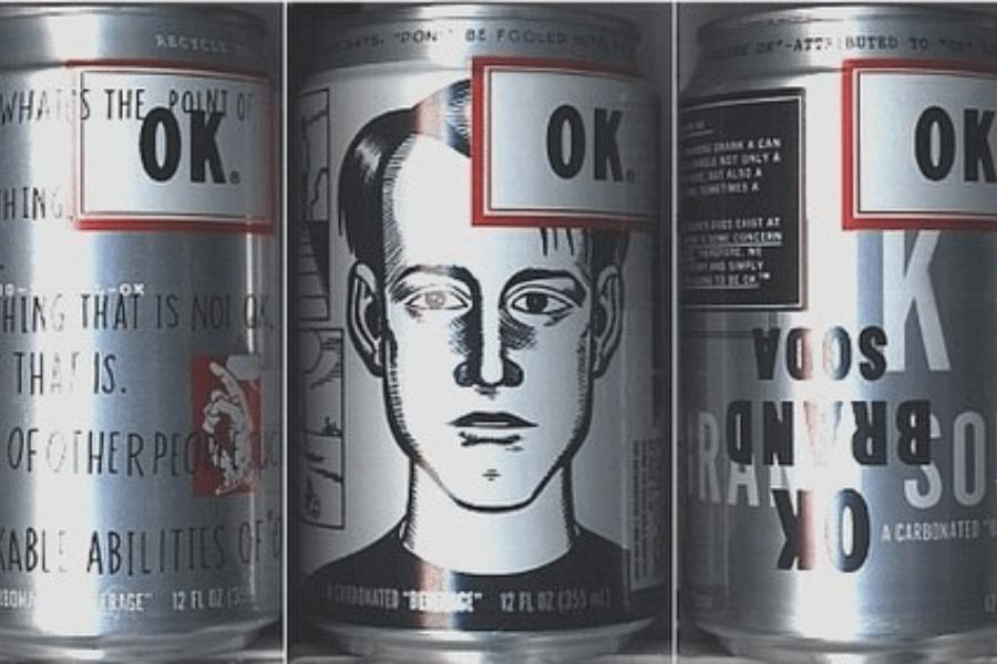 This image shows three sides of a silver can of "OK Soda," a product featuring minimalist and avant-garde design elements. The label includes the "OK" logo in a red-framed white box, abstract text with philosophical musings, and an illustration of a black-and-white sketched face.