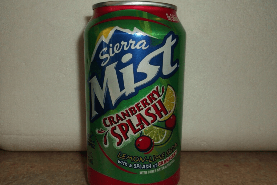 This image features a can of Sierra Mist Cranberry Splash, a lemon-lime soda with a splash of cranberry flavor. The design includes a vibrant green and red color scheme, with images of cranberries and lime slices complementing the festive, fruity theme.