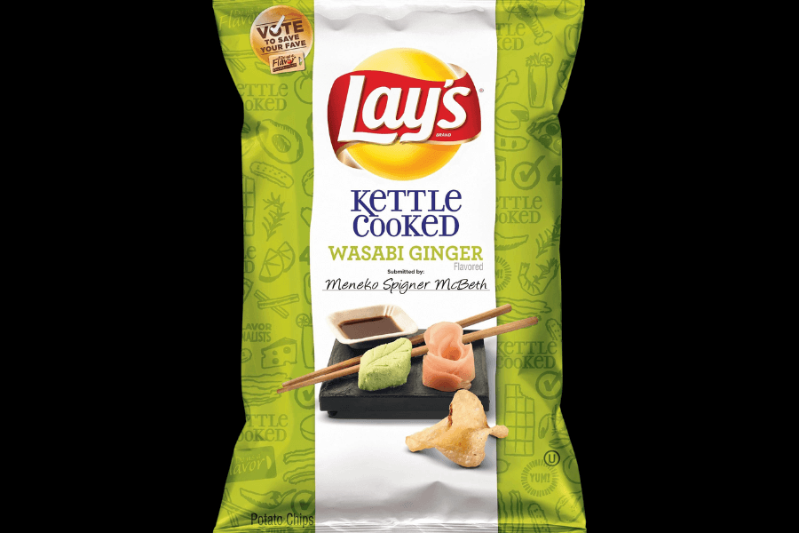 A bag of Lay's Kettle Cooked chips in the "Wasabi Ginger" flavor, featuring a green and white design. The packaging showcases sushi-inspired elements, including wasabi, pickled ginger, and soy sauce, with chopsticks resting on a black tray. The flavor is credited to Meneko Spigner McBeth, and a "Vote to Save Your Fave" promotion is displayed near the top.