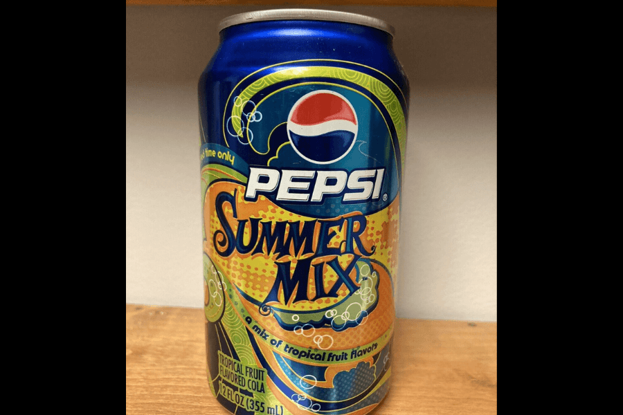 This image features a can of Pepsi Summer Mix, a limited-edition tropical fruit-flavored cola. The design incorporates vibrant blue, yellow, and orange colors with playful tropical graphics, emphasizing its summery and refreshing theme.