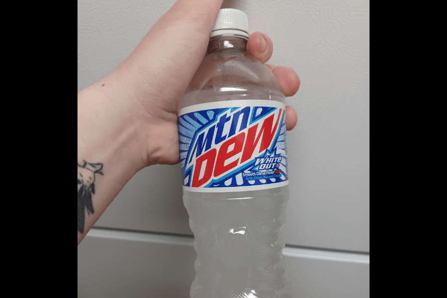 This image shows a bottle of Mountain Dew White Out, featuring a white, cloudy soda and a blue and white label with bold red text. The design emphasizes its smooth citrus flavor, with a clean and crisp aesthetic to match the drink's name.