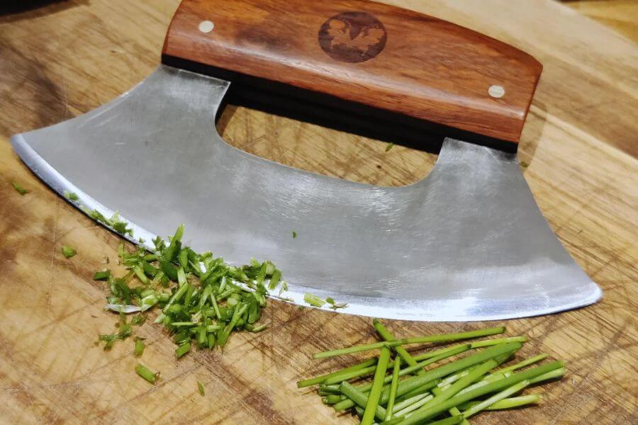 pizza cutter next to herbs