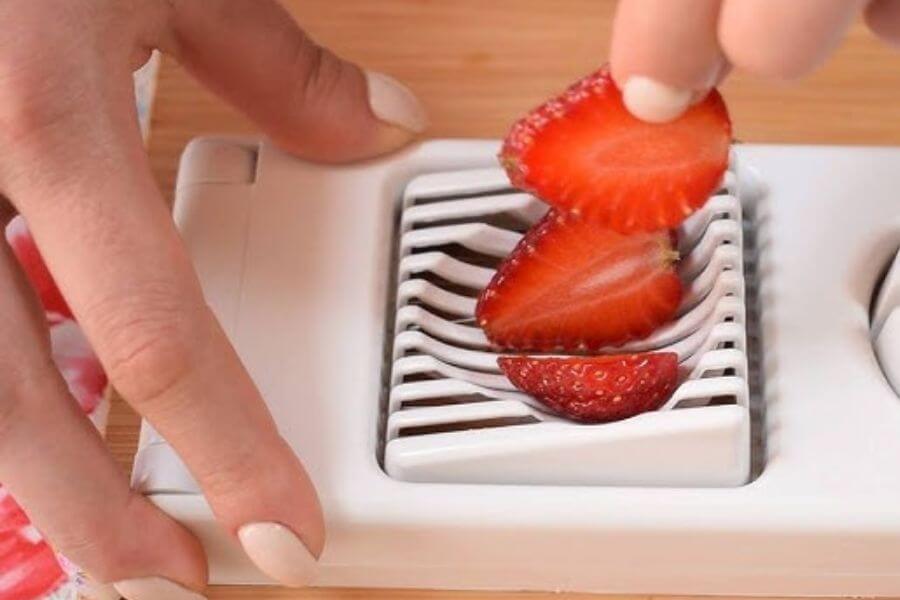 Cutting strawberries with an egg slicer