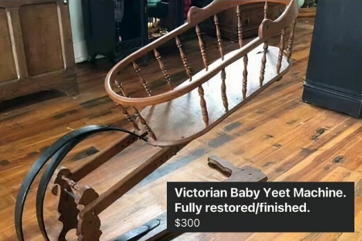 A wooden, vintage cradle-style contraption with a large black spring mechanism attached, positioned on a hardwood floor. The listing humorously titles it "Victorian Baby Yeet Machine," priced at $300, claiming it can launch about 35 feet with upgraded springs.