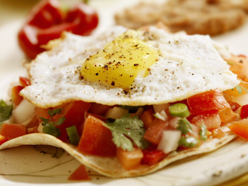 "Huevos Rancheros on Grilled Tortillas with, Fresh Salsa, Refried Beans and Mexican Rice - Photographed on Hasselblad H3D2-39mb Camera"