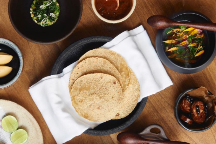 photo taken from above of a set of dishes including taco dough and a variety of toppings