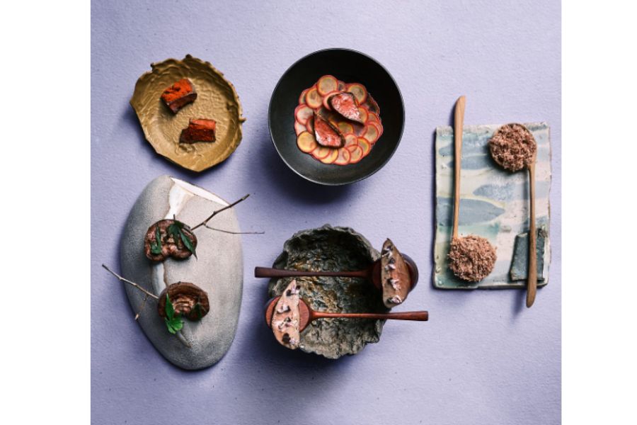 A photo of 5 minimalist fish plates taken from above