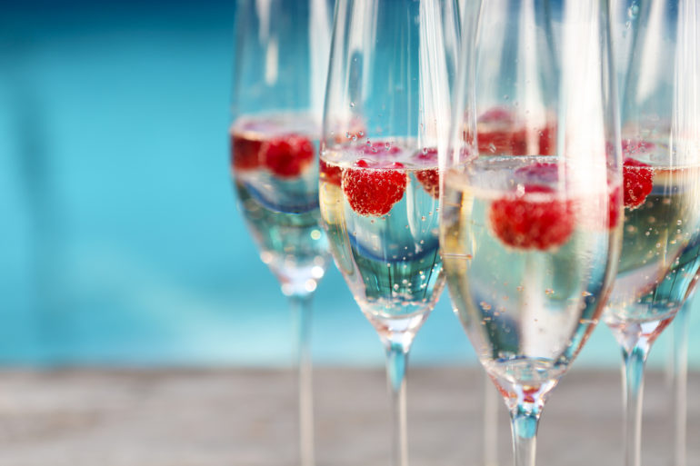 Champagne glasses with raspberry