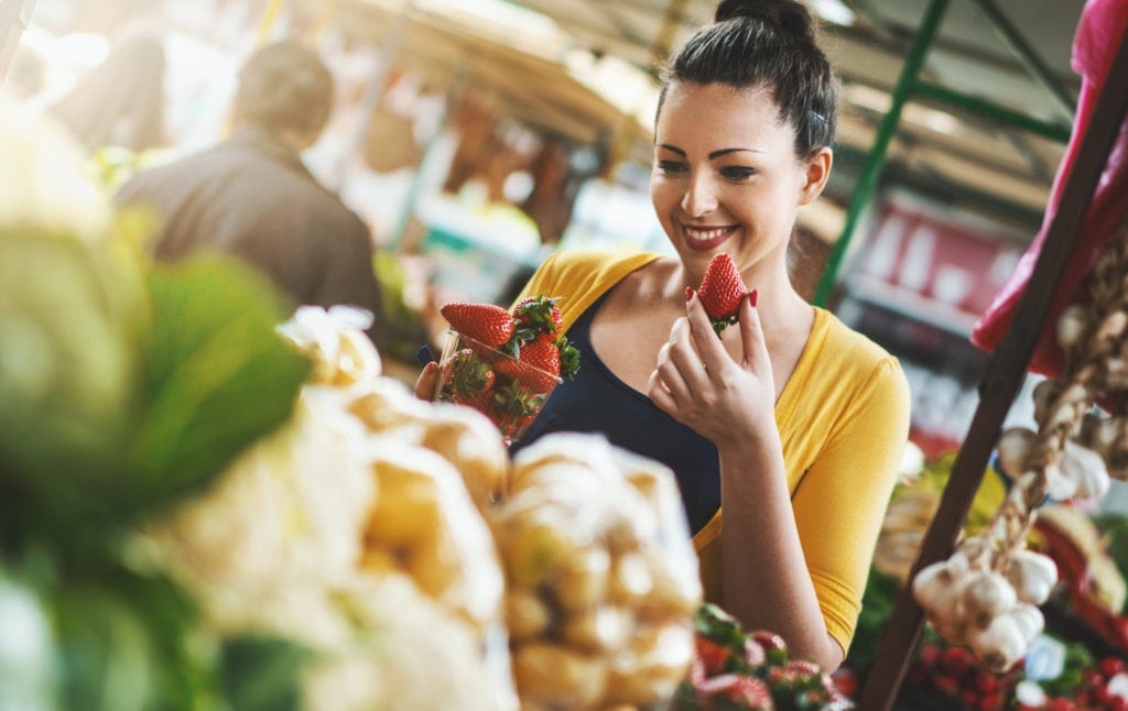 Woman buying fresh fruits and vegetables.