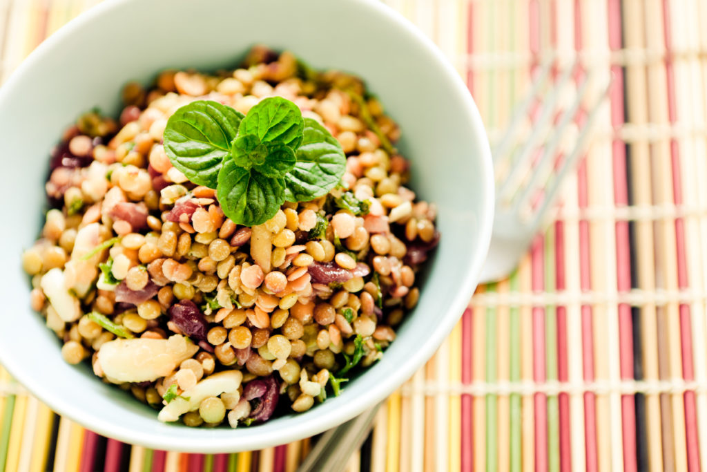 Bowl of lentil salad on table mat