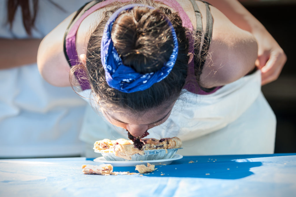 Young Girl Competing in Pie Eating Contest