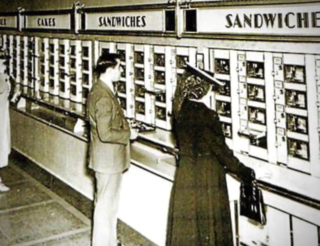 Horn and Hardart Automat, man and woman ordering sandwich at automatic system, sourced from Reddit