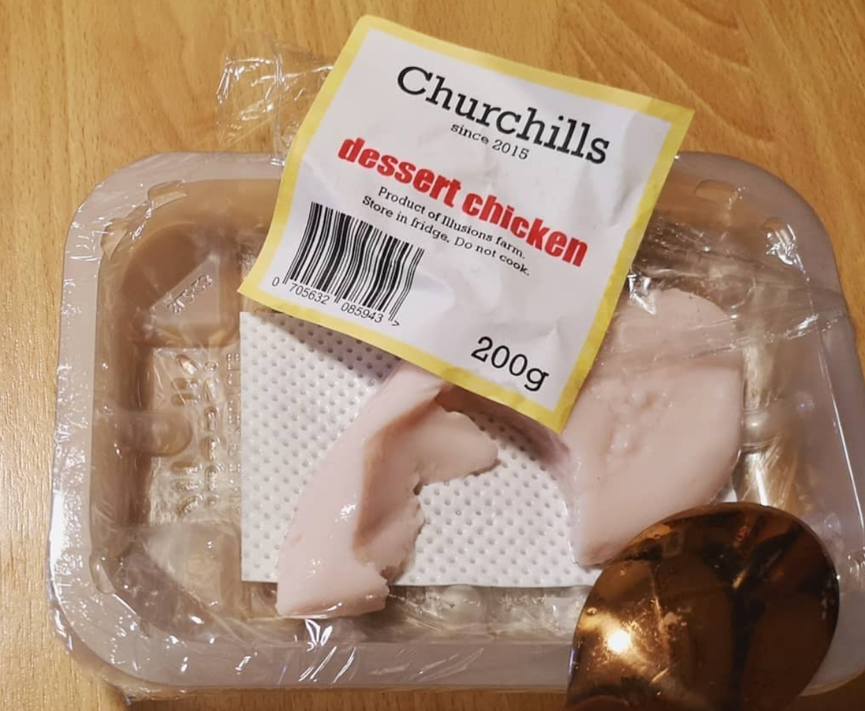 Torn open package of raw chicken, actually made out of dessert, by chefbenchurchill on instagram