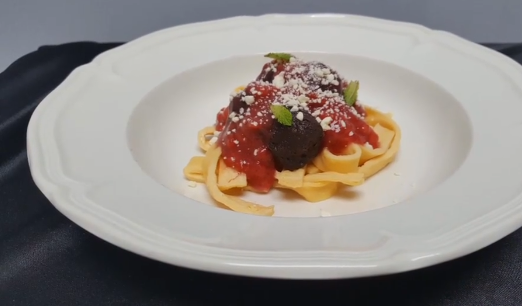 Spaghetti and meatballs dessert illusion on white plate, by chefbenchurchill on instagram