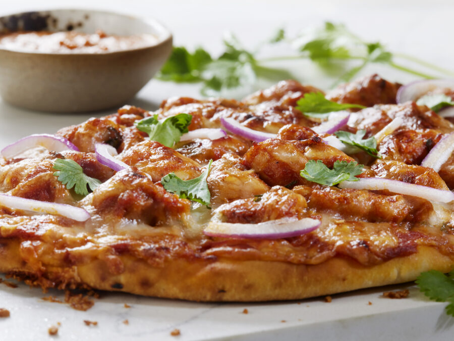 Butter Chicken Pizza on Naan Bread with Red Onion and Cilantro