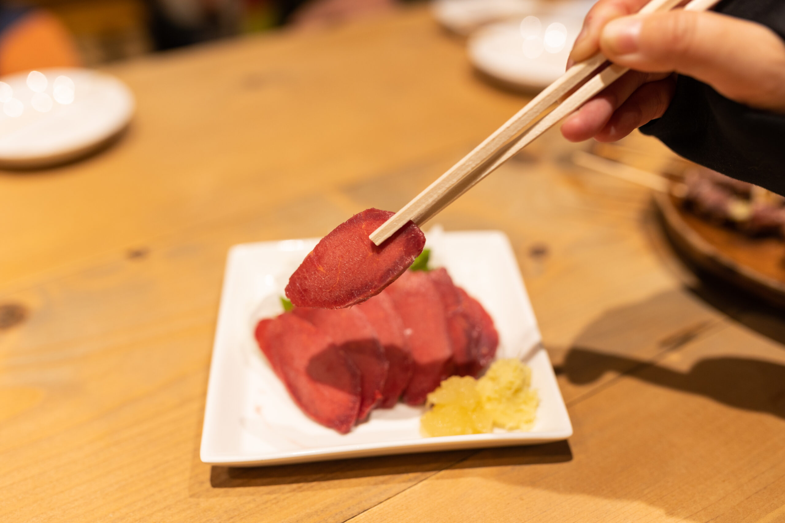 A small plate with a platter of raw horse meat (basashi). A delicacy in Japan.