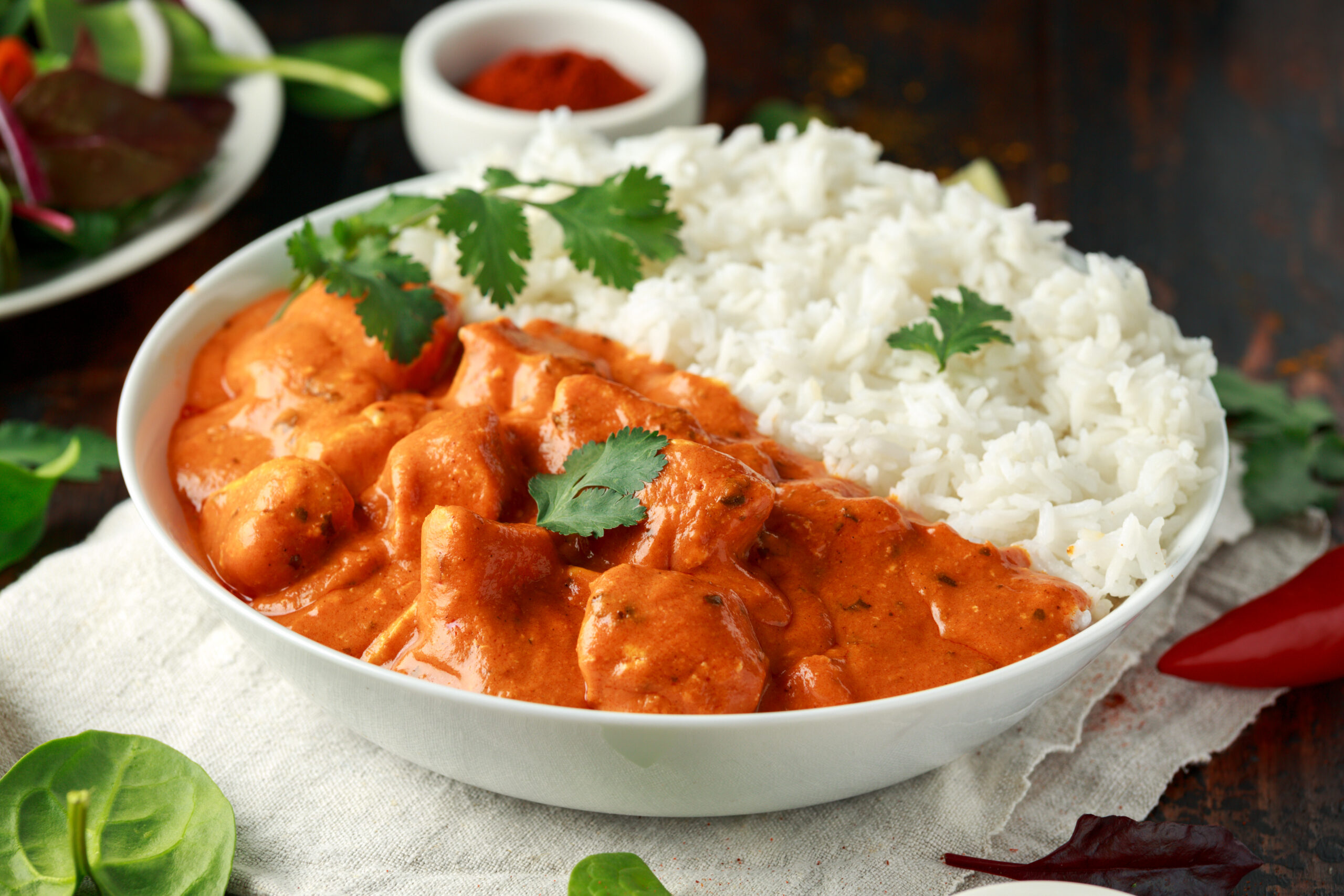 Chicken tikka masala curry with rice and naan bread.