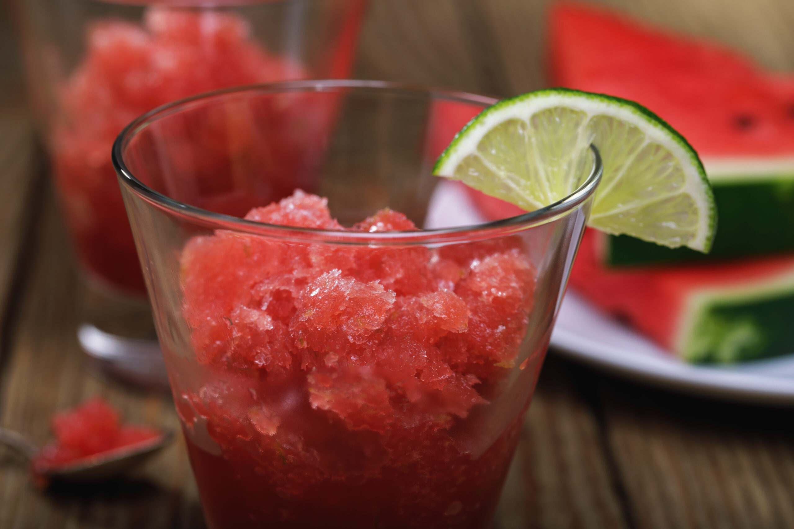 Freshly prepared granite from watermelon and lime on a wooden table, closeup