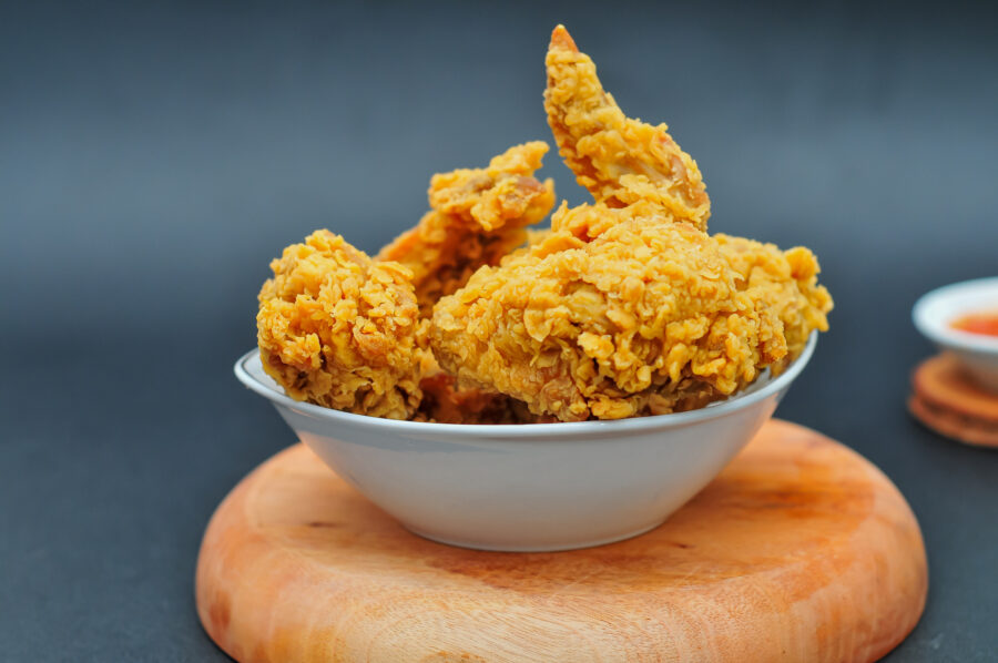 Fried chicken served in a white bowl on a dark background