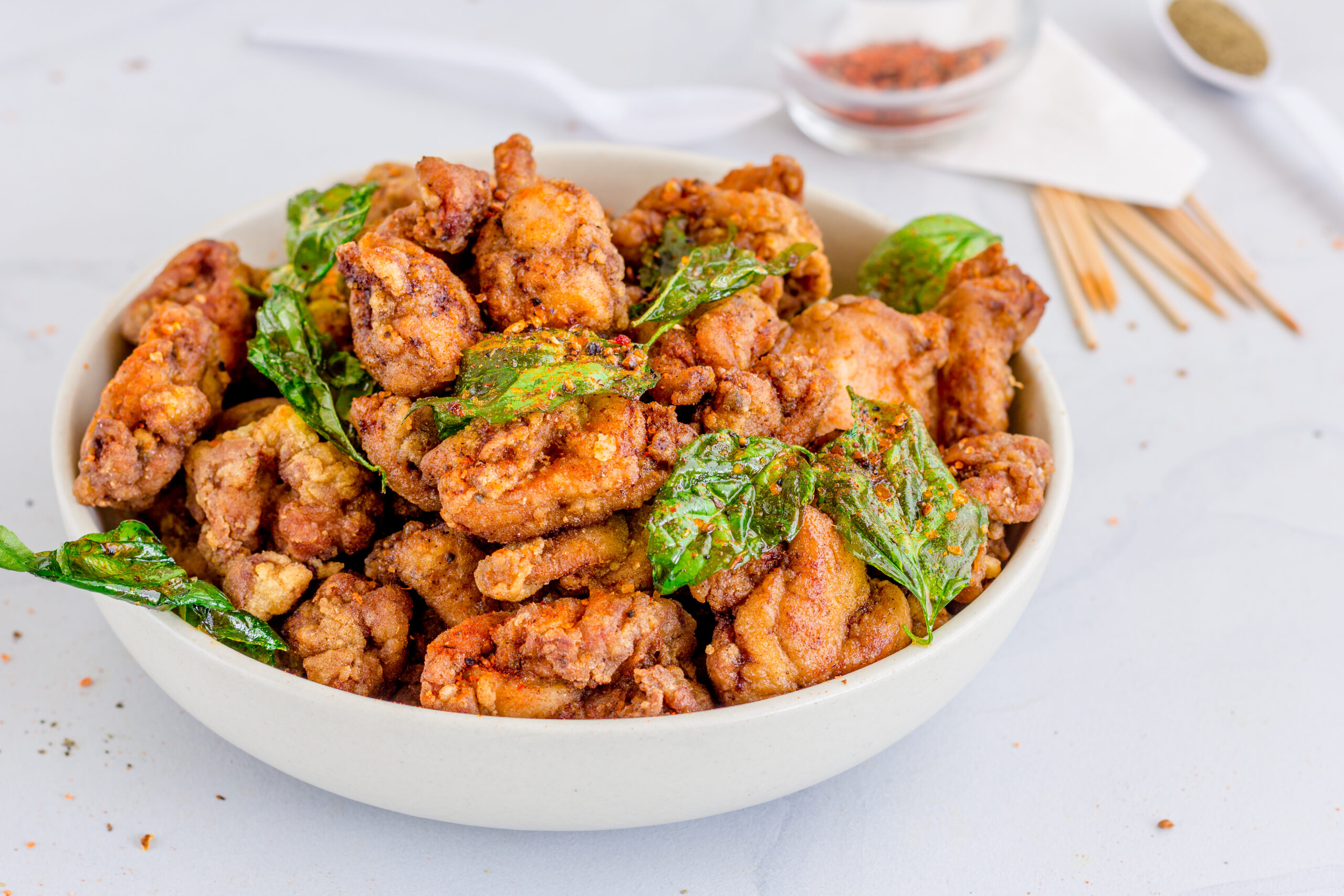 Taiwanese Fried Chicken in a Bowl with Basil Leaves and Seasonings