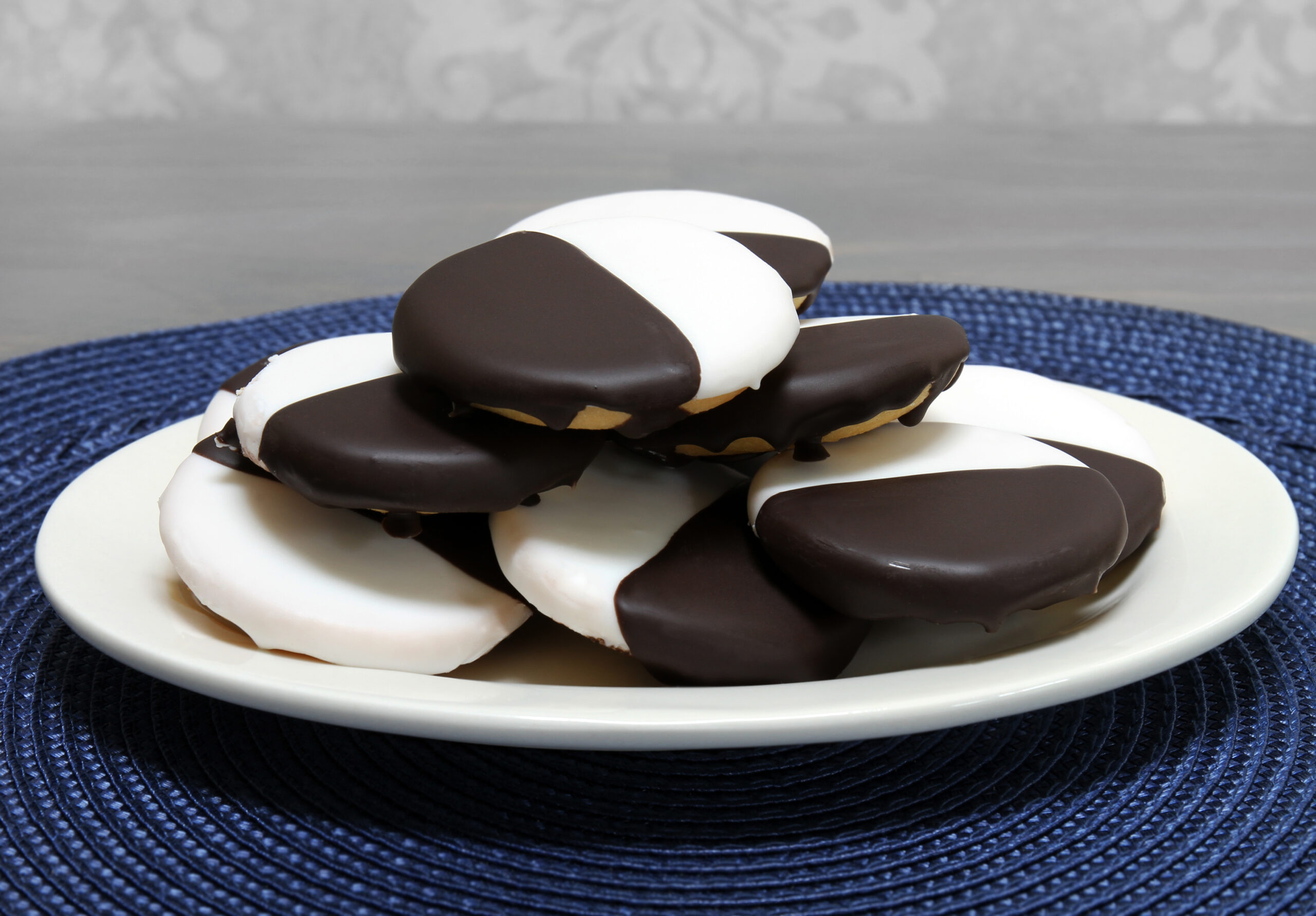 Black and white cookies stacked on an oval plate.  Macro, close up with copy space.