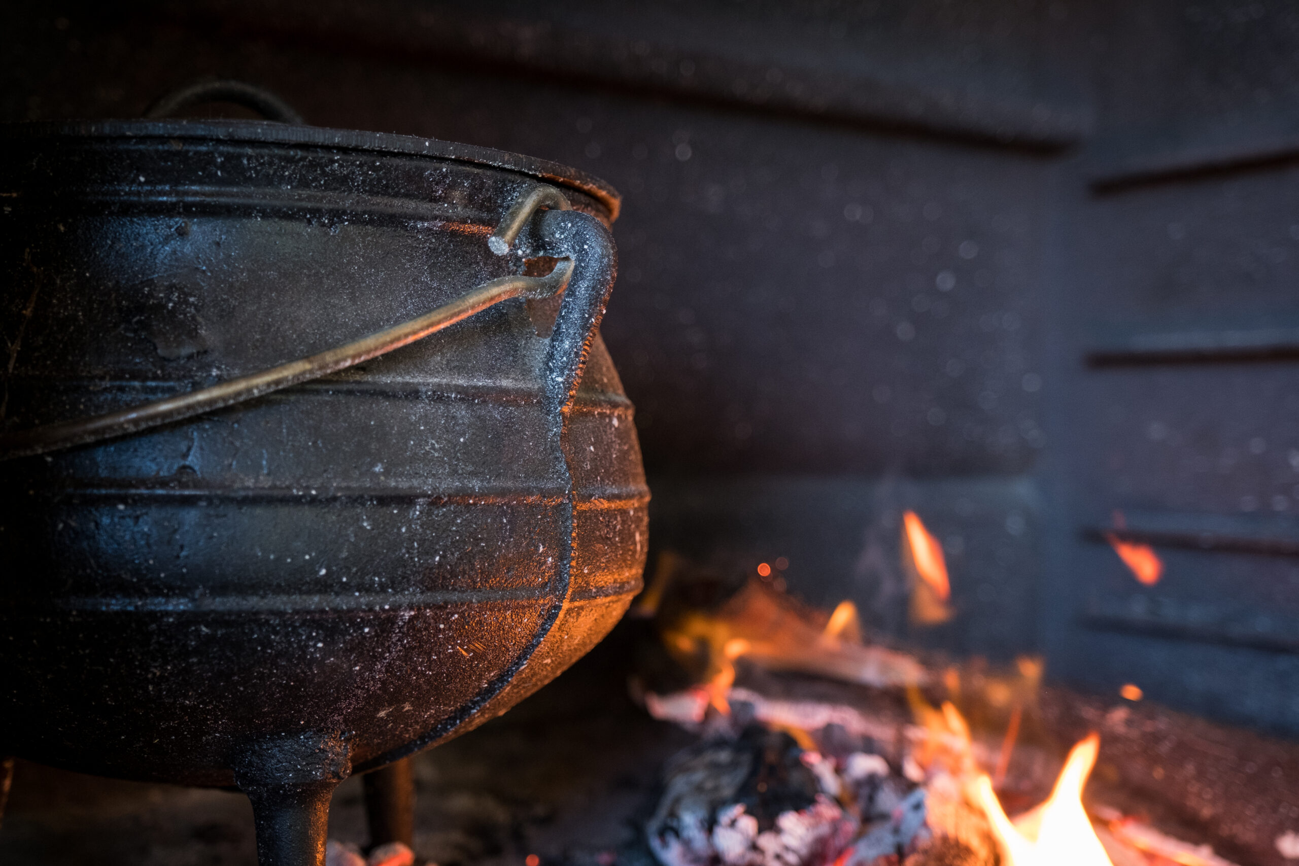 https://soyummy.com/wp-content/uploads/2023/12/food-being-cooked-in-a-large-cast-iron-potjie-pot-stockpack-istock-scaled.jpg