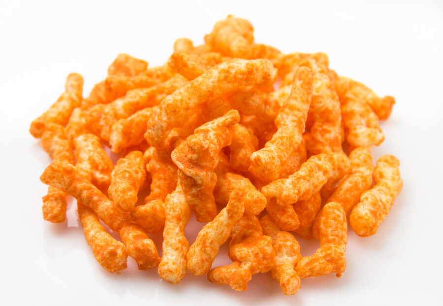 Heap of Cheese Puffs on white background