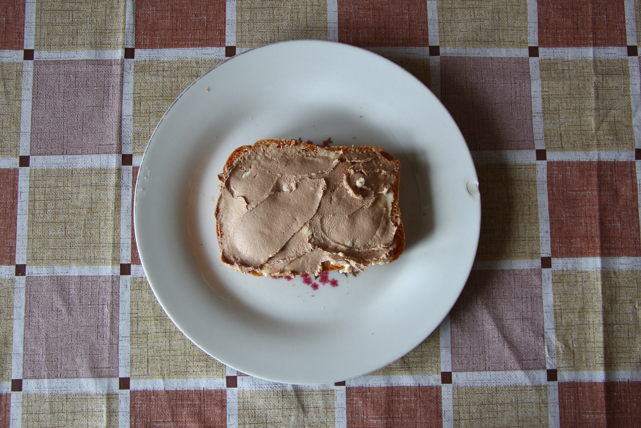 An entire loaf of liver on a white plate.