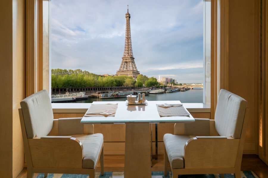 Modern luxury restaurant interior with romantic sence Eiffel Tower and Seine river view in Paris, France. Dinning table in restaurant at Paris, France.