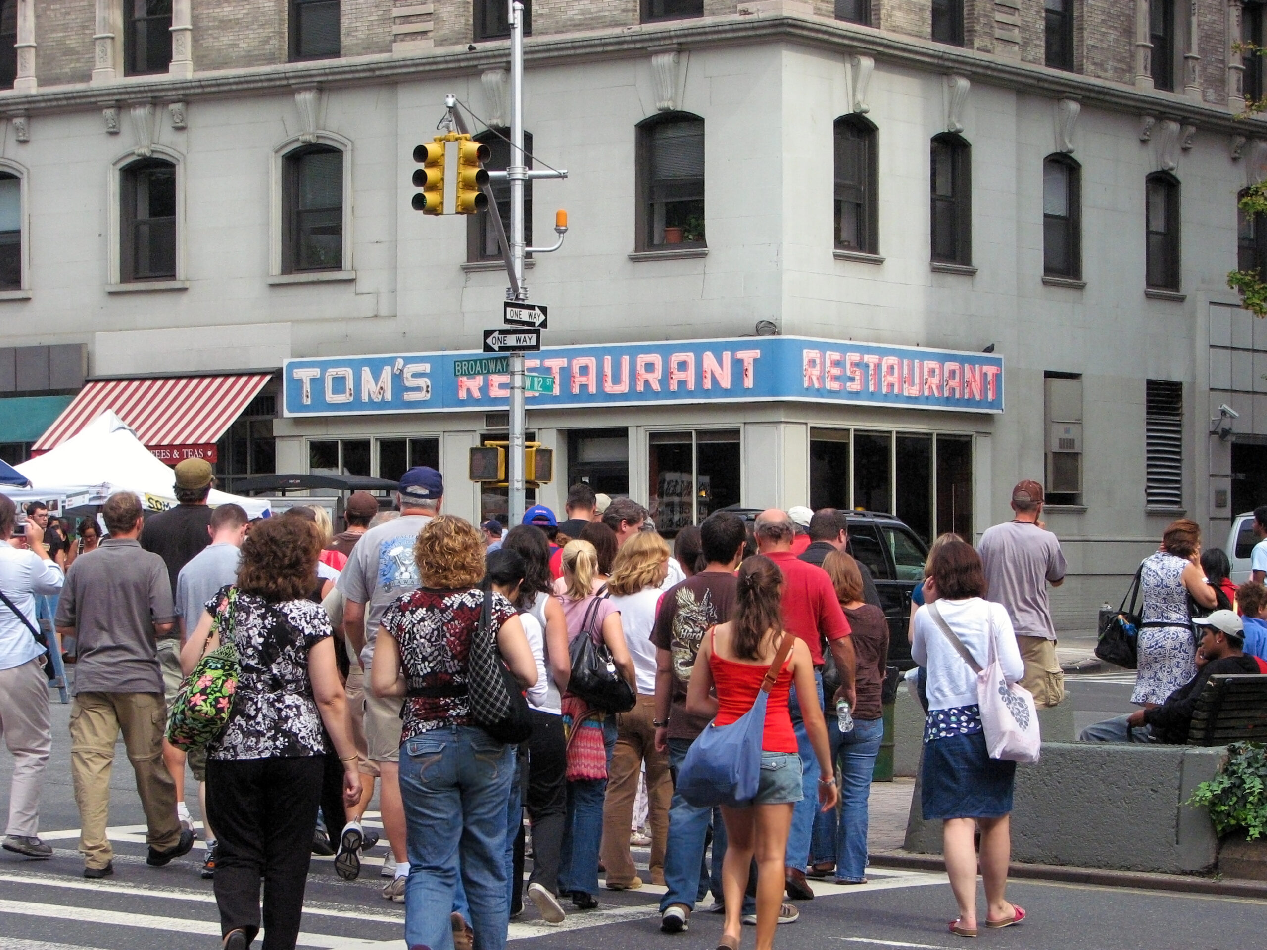 New York, NY, USA - September 13, 2008:  People head towards Tom's Restaurant which was used as the exterior shot for Monk's in popular sitcom Seinfeld during a stop on Kramer's Reality Tour run by Kenny Kramer, the real Kramer.