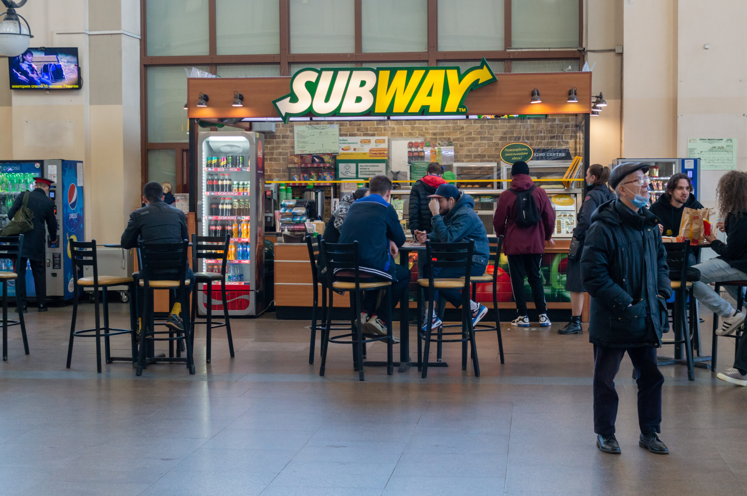 people at tables in Subway. Selective focus