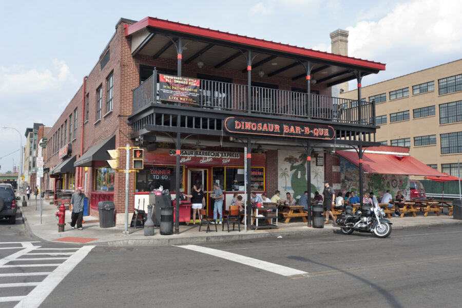 Syracuse, NY, USA - August 22, 2013: People eating at Dinosaur Bar-B-Que restaurant in downtown Syracuse, New York. Dinosaur Bar-B-Que is a chain of restaurants in New York, New Jersey and Connecticut featuring authentic southern barbecue which opened in Syracuse in 1988.