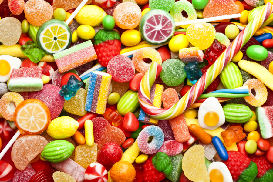 Top view of colorful candies, jellybeans and lollipops background. DSRL studio photo taken with Canon EOS 5D Mk II and Canon EF 100mm f/2.8L Macro IS USM