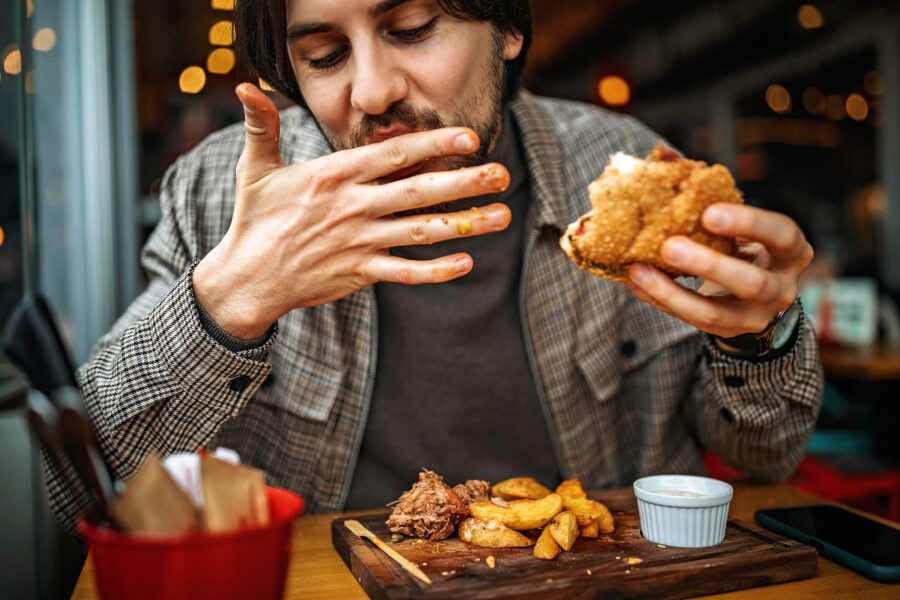 A man eating his food quickly